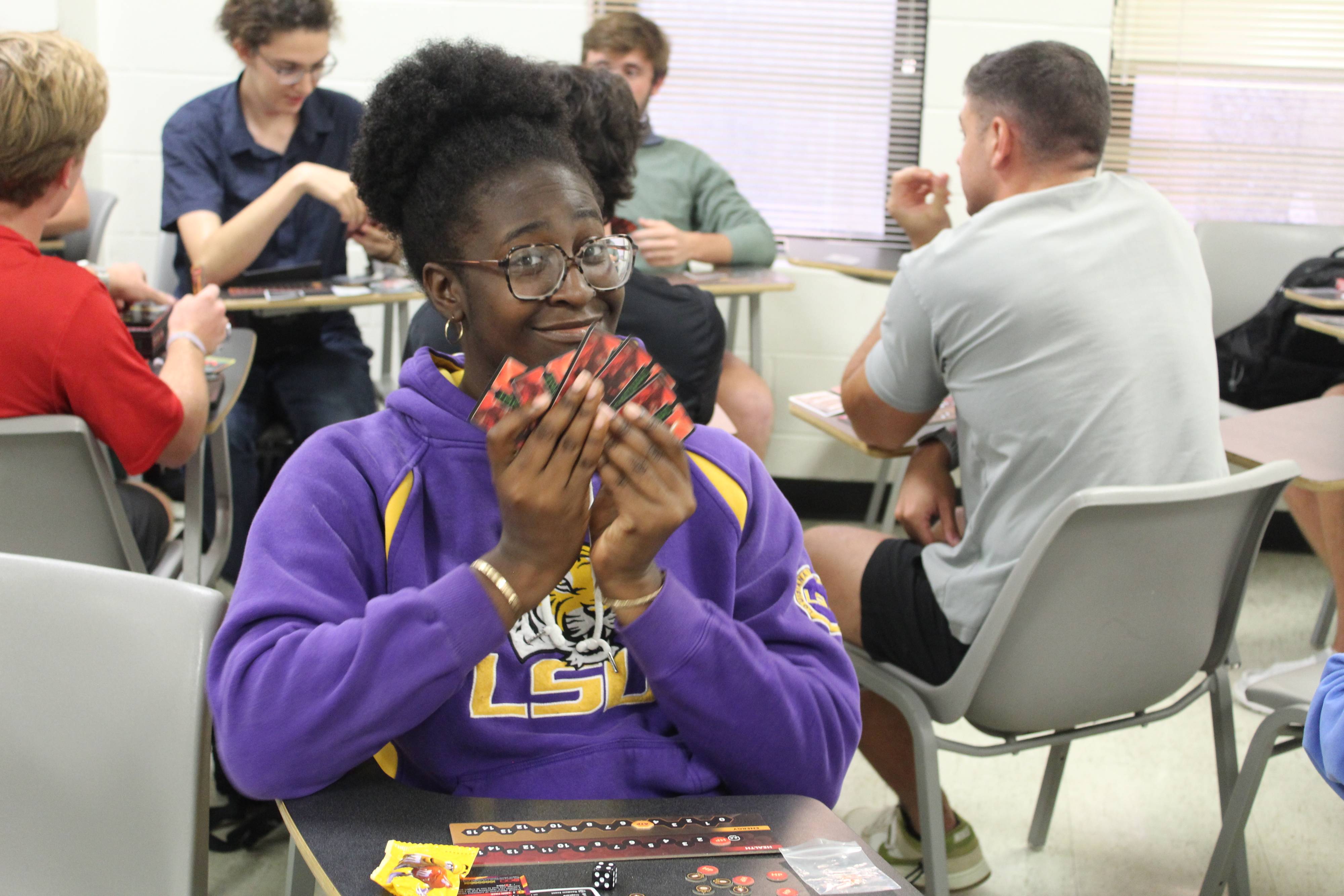 LSU student holds cards for the game ImmunoWars