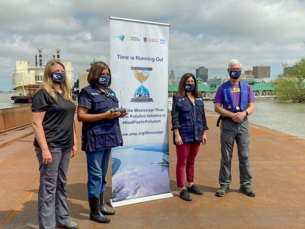 Four people, including Mark Benfield and Baton Rouge Mayor Sharon Weston Broome pose with an MRCTI banner in downtown Baton Rouge