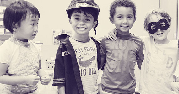 Black and white photo of four little boys.