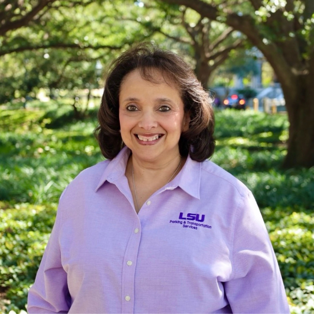 smiling woman in purple polo