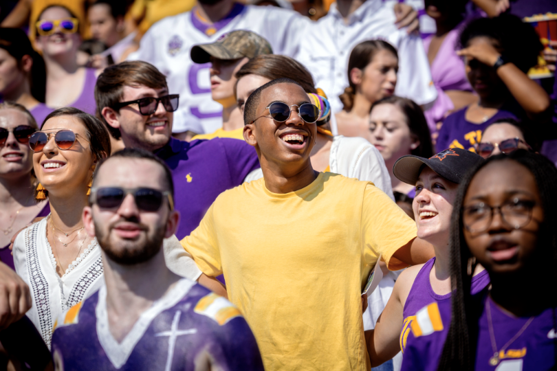 student smiling in tiger stadium