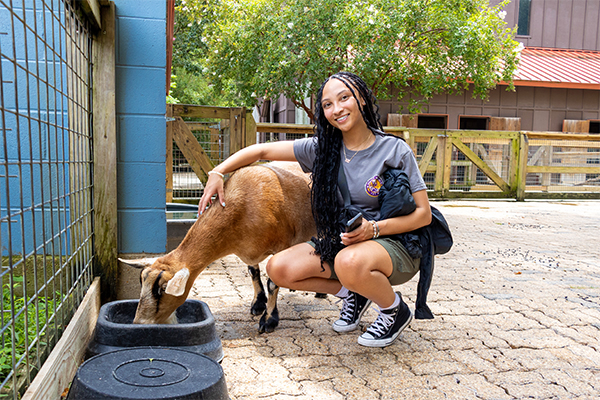 student with goat
